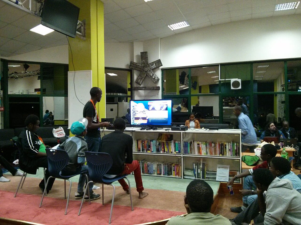 Console setup at a gaming event in Nairobi wallpaper in near-black and olive tones, Full HD, 4:3 format for phone
