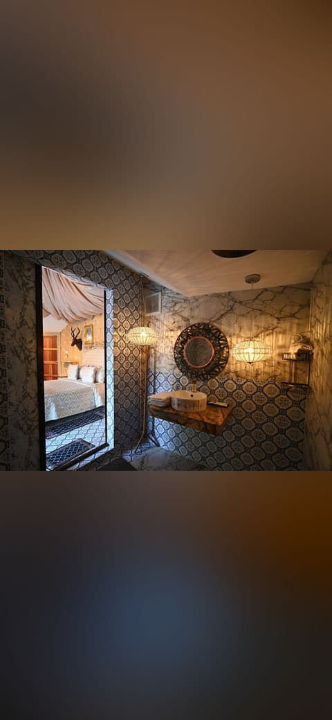 A cozy eclectic suite where patterned tile and… wallpaper in near-black and charcoal tones, Full HD, 4:3 format for phone