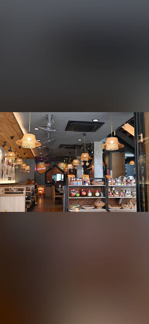 Cozy cafe interior with warm hanging wicker lamps… wallpaper in near-black and olive tones, Full HD, 4:3 format for phone